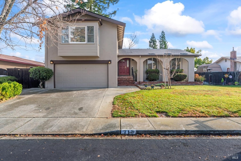 view of front of home with a front lawn and a garage