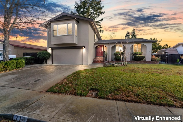 view of front property with a garage and a lawn