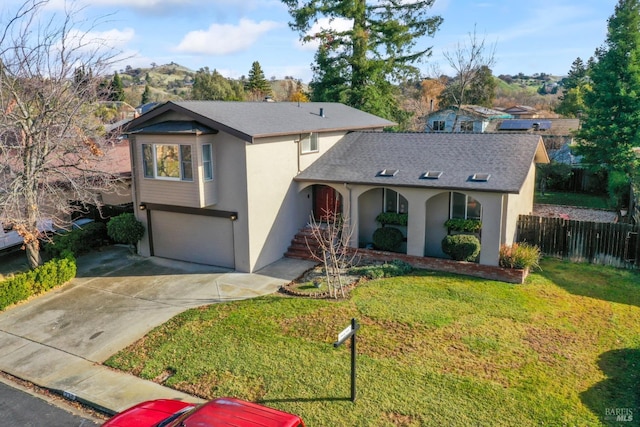 view of front of property with a front yard and a garage