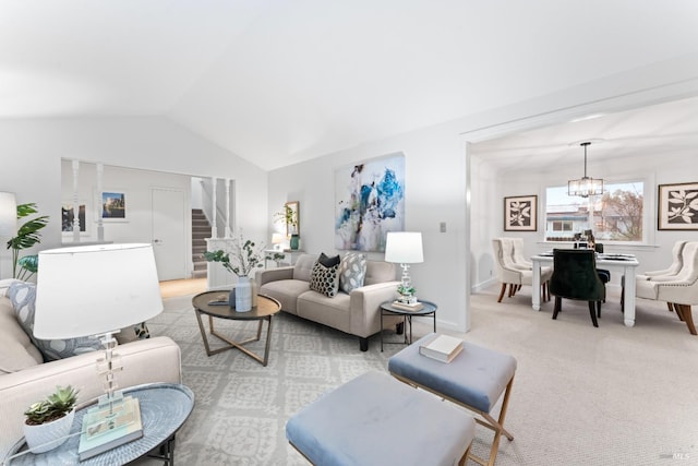 carpeted living room with a notable chandelier and vaulted ceiling