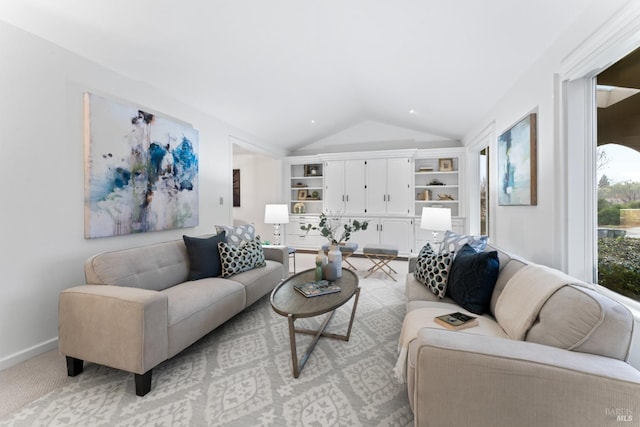 carpeted living room featuring vaulted ceiling