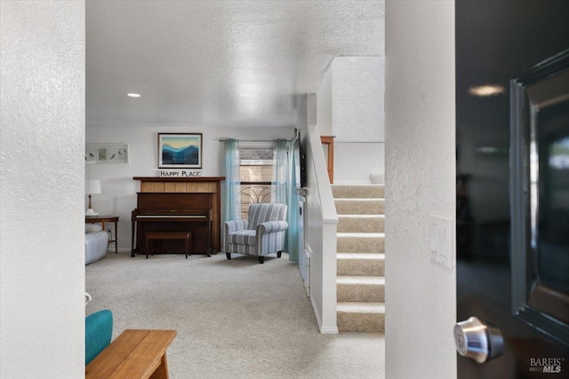 interior space featuring carpet and a textured ceiling