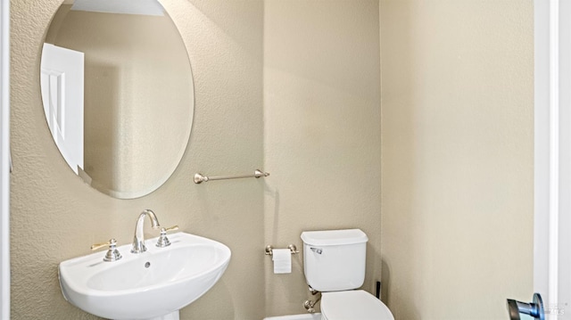 bathroom with toilet and sink