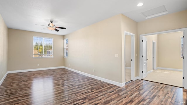 empty room featuring ceiling fan and dark hardwood / wood-style flooring