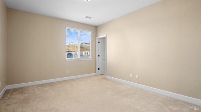 empty room with light colored carpet