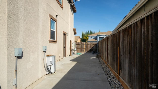 view of side of property with a patio area