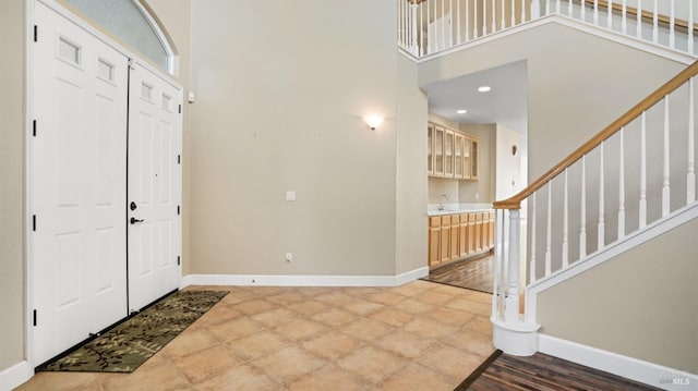 entrance foyer with a towering ceiling and sink