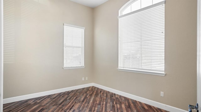 unfurnished room with dark hardwood / wood-style floors