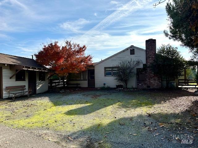 view of side of home featuring a yard