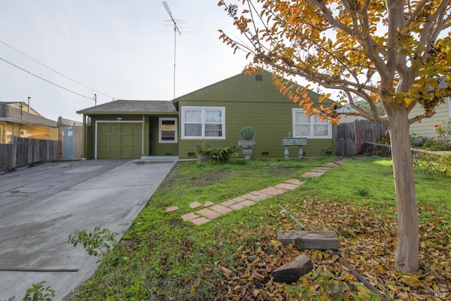 ranch-style home with a front yard and a garage