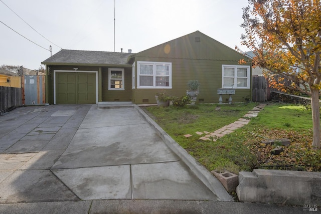 ranch-style home featuring a front yard and a garage