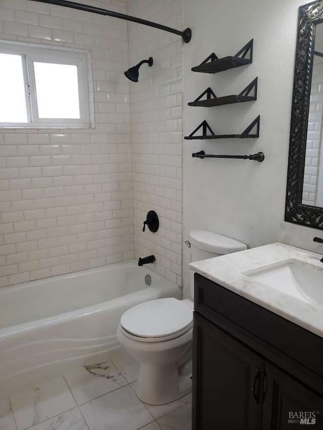 bathroom featuring vanity, toilet, tub / shower combination, and marble finish floor