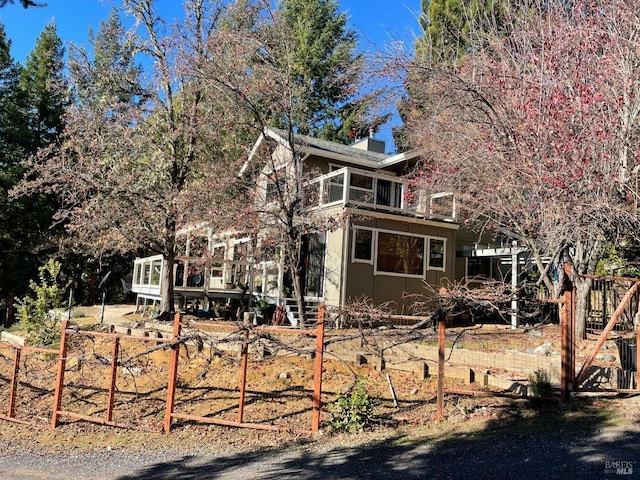 view of side of home with a deck