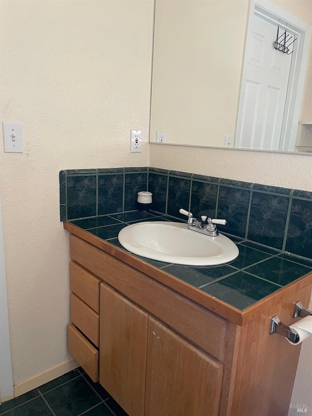 bathroom with backsplash, tile patterned floors, and vanity