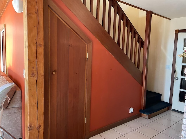 staircase with tile patterned floors