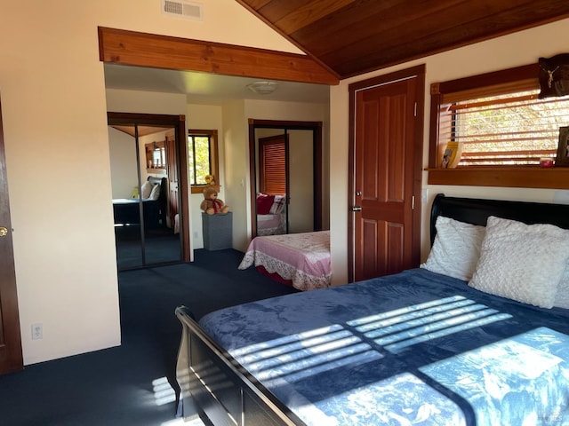 bedroom featuring multiple closets, carpet, wood ceiling, and lofted ceiling