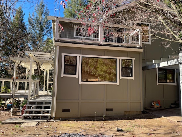 view of home's exterior featuring a balcony, a pergola, and a deck