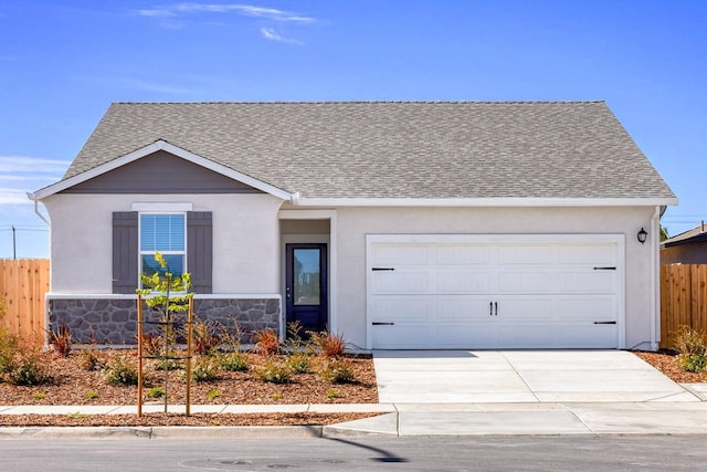 ranch-style home with a garage, fence, stone siding, a shingled roof, and concrete driveway