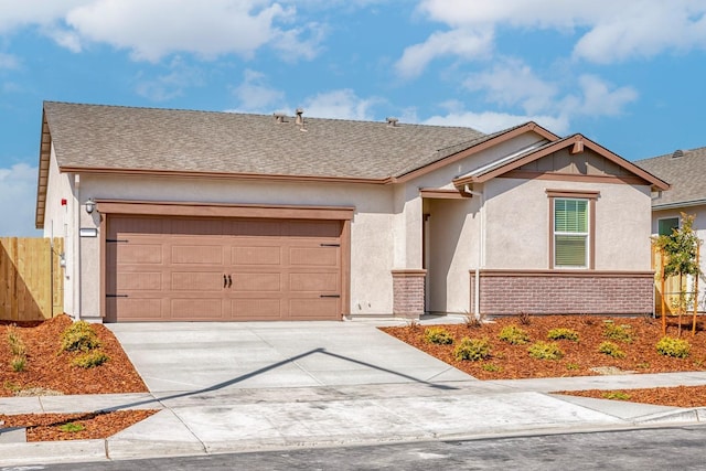 ranch-style house with a garage, brick siding, concrete driveway, fence, and stucco siding