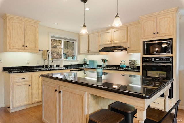 kitchen featuring appliances with stainless steel finishes, light hardwood / wood-style floors, light brown cabinetry, and sink