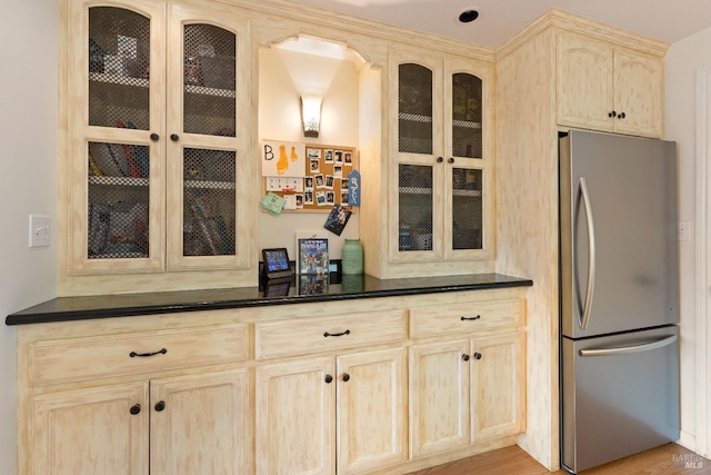 kitchen featuring stainless steel fridge, light brown cabinets, and light hardwood / wood-style floors