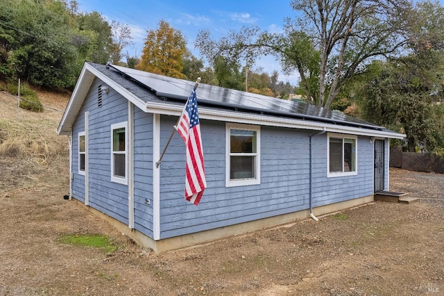 view of property exterior with solar panels