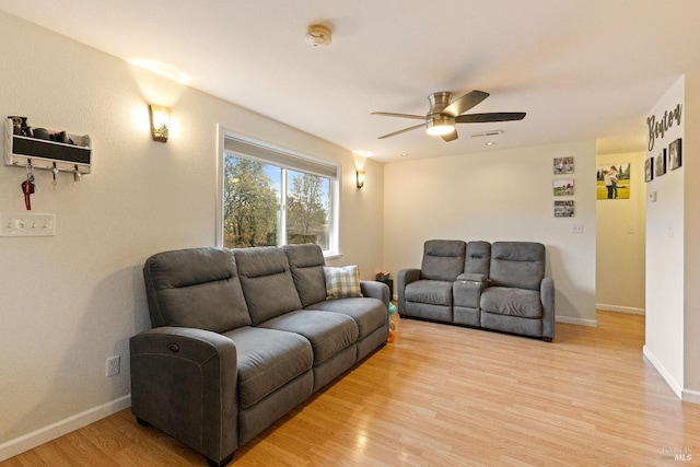 living room featuring light wood-type flooring and ceiling fan