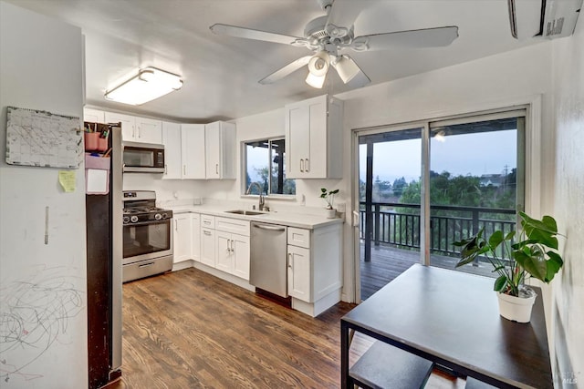 kitchen featuring white cabinets, sink, dark hardwood / wood-style floors, ceiling fan, and appliances with stainless steel finishes