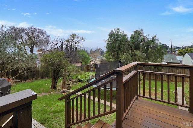 deck with a trampoline and a lawn