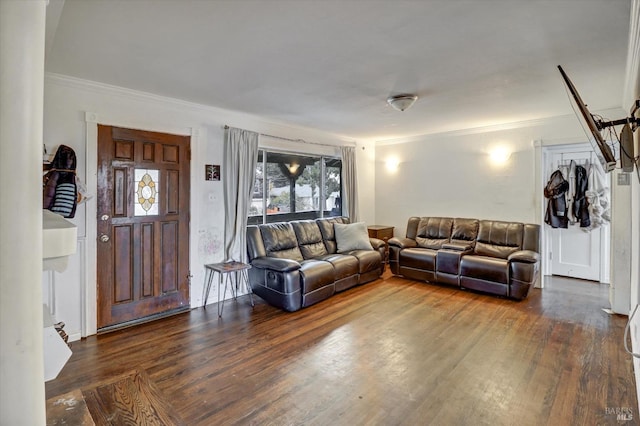 living room with dark hardwood / wood-style flooring and ornamental molding