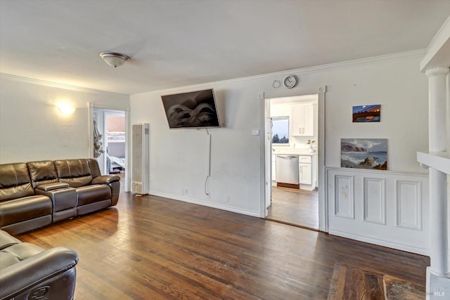 living room featuring dark hardwood / wood-style floors, plenty of natural light, and ornamental molding