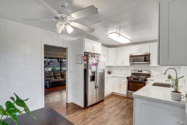 kitchen featuring white cabinets, stainless steel appliances, dark wood-type flooring, and sink