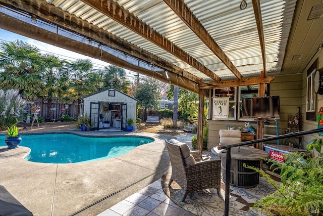 view of pool featuring a fenced in pool, an outbuilding, a patio area, and fence
