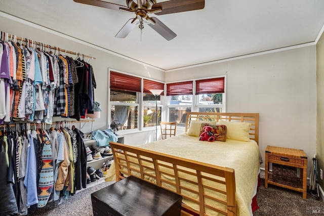 carpeted bedroom with a ceiling fan and crown molding