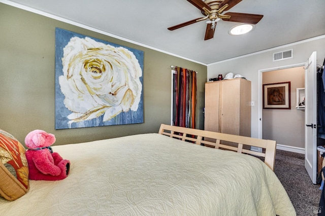 bedroom with carpet floors, visible vents, crown molding, and baseboards