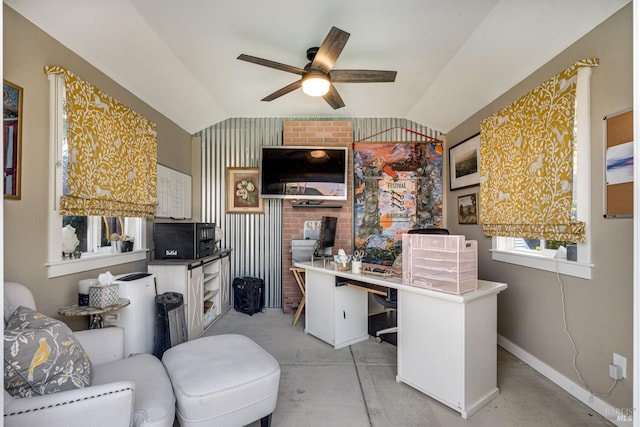 office featuring vaulted ceiling, ceiling fan, concrete floors, and baseboards