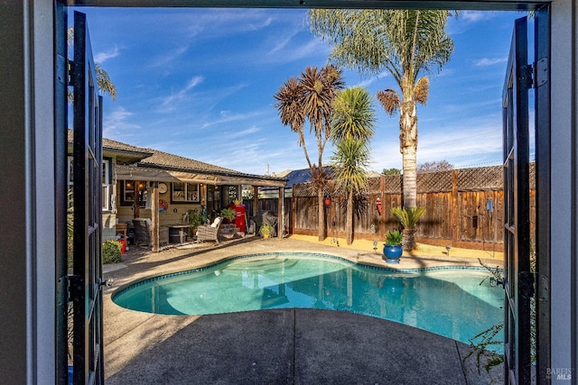 view of pool featuring a patio area, a fenced backyard, and a fenced in pool