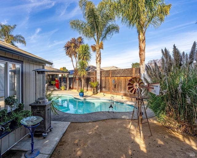 view of pool featuring a patio area, a fenced backyard, a fenced in pool, and a gazebo