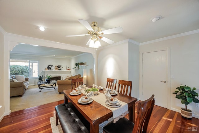 dining room with hardwood / wood-style flooring, ceiling fan, and crown molding