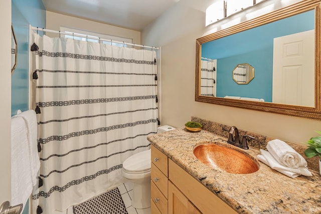 bathroom with tile patterned floors, vanity, a shower with shower curtain, and toilet