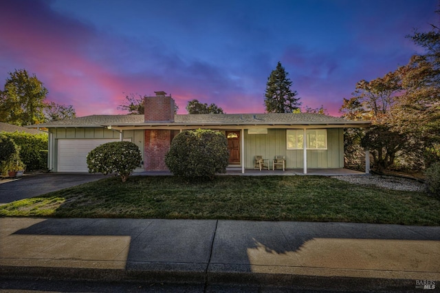 ranch-style home with a lawn and a garage