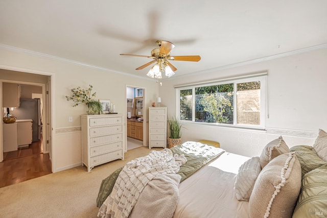 carpeted bedroom with stainless steel fridge, ensuite bathroom, ceiling fan, and ornamental molding