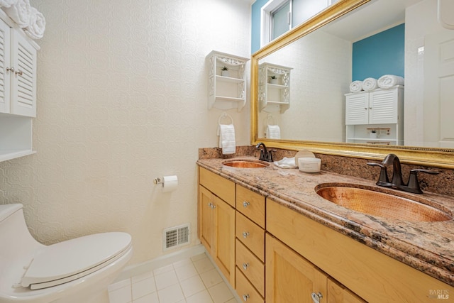 bathroom with tile patterned flooring, vanity, and toilet