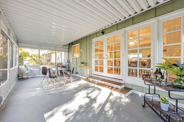 sunroom / solarium featuring french doors