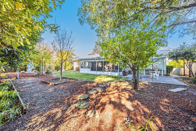 view of yard featuring a patio and a sunroom