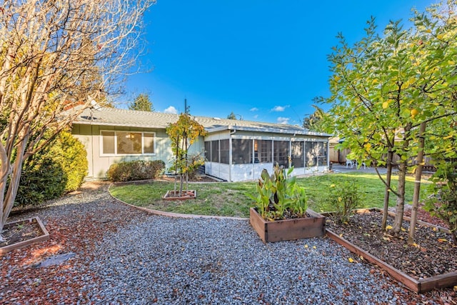 back of house with a sunroom and a yard