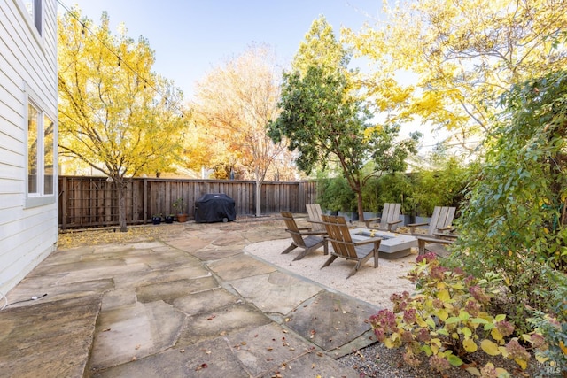 view of patio featuring a fire pit and a grill