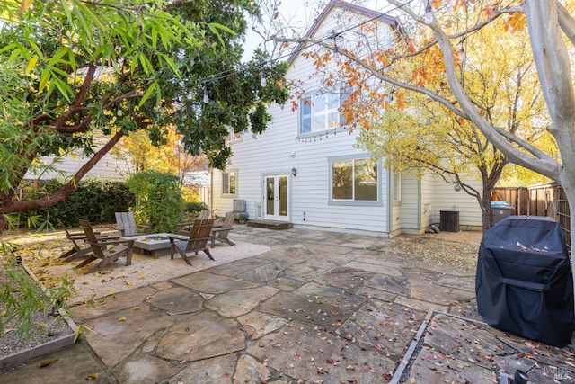 view of patio with grilling area, a fire pit, and cooling unit