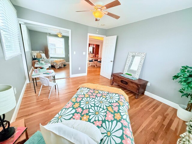 living room with ceiling fan and light wood-type flooring