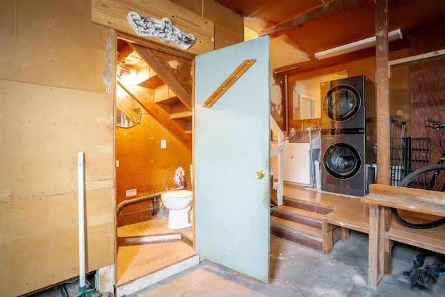 interior space with stacked washer and dryer and concrete flooring